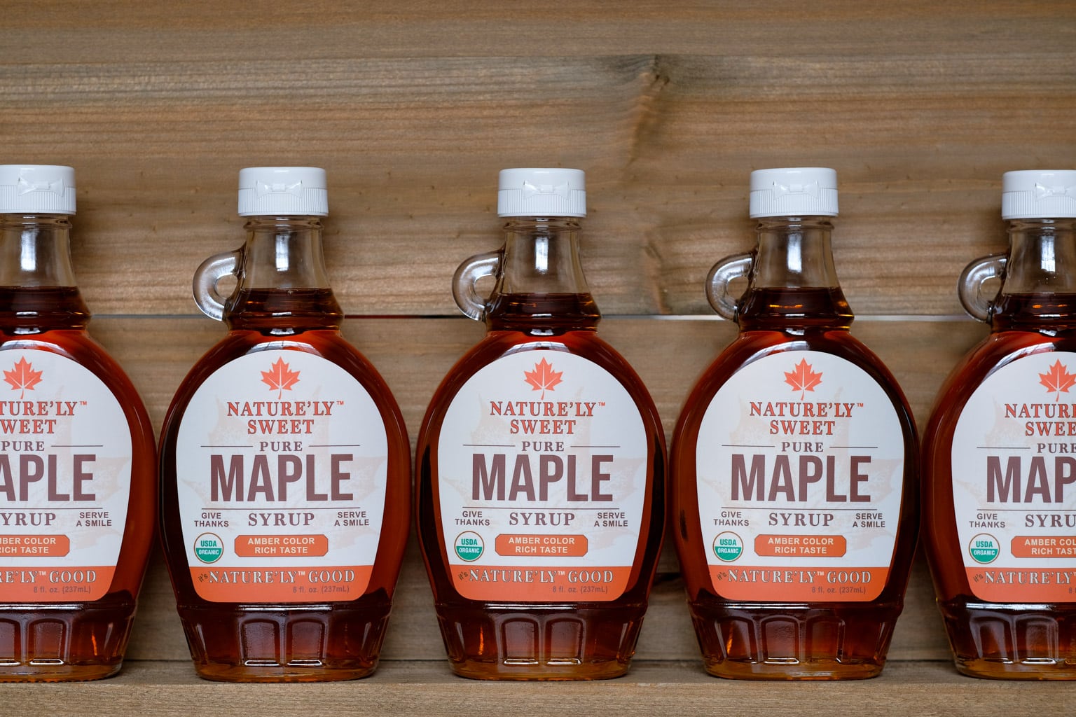 8oz bottles of organic maple syrup on shelf